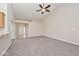 Expansive living room space with vaulted ceilings and carpeted floors at 10668 Whippoorwill Ln, Indianapolis, IN 46231