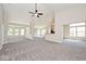 Spacious living room with neutral walls, plush carpet, and abundant natural light at 10668 Whippoorwill Ln, Indianapolis, IN 46231