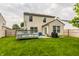 Beautiful backyard showcases a deck, BBQ, green lawn, garden, and fenced perimeter, perfect for outdoor living at 1112 Halifax Ct, Indianapolis, IN 46231