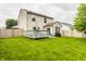 Sprawling backyard featuring green lawn, deck with seating, BBQ and fenced perimeter for outdoor enjoyment at 1112 Halifax Ct, Indianapolis, IN 46231