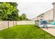 Expansive backyard showcases green lawn, wood and vinyl fences, and a deck for outdoor enjoyment at 1112 Halifax Ct, Indianapolis, IN 46231