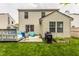 Backyard view featuring a well-maintained lawn, a deck, garden, and a grill for outdoor entertaining at 1112 Halifax Ct, Indianapolis, IN 46231