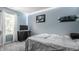 Comfortable bedroom with blue walls, soft carpet, and relaxed ambiance at 1112 Halifax Ct, Indianapolis, IN 46231