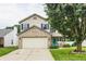 Charming two-story home featuring a brick-accented facade, attached garage, and inviting covered porch at 1112 Halifax Ct, Indianapolis, IN 46231