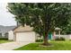 Beautifully landscaped yard with large tree accenting the exterior of this two-story home at 1112 Halifax Ct, Indianapolis, IN 46231