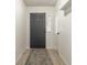 Clean and bright foyer with tile flooring, a neutral-colored rug, and a conveniently placed coat rack at 1112 Halifax Ct, Indianapolis, IN 46231