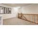 Hallway featuring neutral carpeting, natural wood trim and doors, and framed artwork that creates a warm and inviting space at 1112 Halifax Ct, Indianapolis, IN 46231
