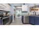 Modern kitchen with stainless steel appliances, light countertops, and ample cabinet space, creating a functional and stylish cooking space at 1112 Halifax Ct, Indianapolis, IN 46231