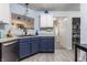 This home's kitchen features updated appliances and stylish blue lower cabinets, blending functionality with modern design at 1112 Halifax Ct, Indianapolis, IN 46231