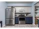 Modern kitchen with stainless steel appliances, light countertops, and ample cabinet space, creating a functional and stylish cooking space at 1112 Halifax Ct, Indianapolis, IN 46231