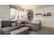 Inviting living room with a comfortable gray sofa, stylish decor, and lots of sunlight at 1112 Halifax Ct, Indianapolis, IN 46231