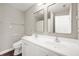 Bathroom featuring double sinks, a white vanity and well-lit mirrors at 11138 Bear Hollow Dr, Indianapolis, IN 46229