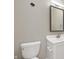 Clean bathroom featuring a white toilet, vanity, and a large mirror at 11138 Bear Hollow Dr, Indianapolis, IN 46229