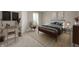 Cozy bedroom featuring stylish decor, a modern bed frame, and a comfortable seating area at 11138 Bear Hollow Dr, Indianapolis, IN 46229