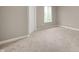 A clean and bright bedroom with neutral walls, carpet, white trim, and a window at 11138 Bear Hollow Dr, Indianapolis, IN 46229