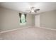 Spacious bedroom with a ceiling fan, plush carpeting, and a well-lit window at 11138 Bear Hollow Dr, Indianapolis, IN 46229