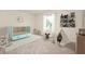Charming Bedroom with a modern blue crib, decorative shelving, and a playful teepee tent at 11138 Bear Hollow Dr, Indianapolis, IN 46229