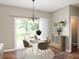 Cozy dining area with a modern table set and view to the backyard through sliding glass doors at 11138 Bear Hollow Dr, Indianapolis, IN 46229