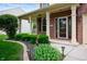 Welcoming front porch with brick pillars, tasteful landscaping, and a storm door at 11138 Bear Hollow Dr, Indianapolis, IN 46229