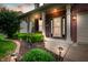 Inviting front porch with white pillars, brick accents, and decorative landscaping with solar lights at 11138 Bear Hollow Dr, Indianapolis, IN 46229