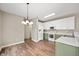 Well-lit kitchen featuring white upper cabinets and sage green lower cabinets at 11138 Bear Hollow Dr, Indianapolis, IN 46229
