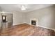 Cozy living room with a fireplace and hardwood floors, adjacent to entry with oval window door at 11138 Bear Hollow Dr, Indianapolis, IN 46229