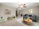 Inviting living room with a blue sofa, colorful artwork, and a play area at 11138 Bear Hollow Dr, Indianapolis, IN 46229