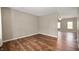 Open-concept living room with hardwood floors and a view into another space beyond at 11138 Bear Hollow Dr, Indianapolis, IN 46229
