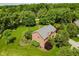 Aerial view of brick home with lush lawn, mature trees, and privacy landscaping at 11354 Royal Pl, Carmel, IN 46032