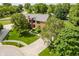 A beautiful brick home with mature trees, green lawn, and a long driveway at 11354 Royal Pl, Carmel, IN 46032