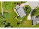 Aerial view of lush property with manicured lawn, mature trees and circular driveway at 11354 Royal Pl, Carmel, IN 46032