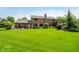 Expansive green backyard featuring mature trees and manicured landscaping at 11354 Royal Pl, Carmel, IN 46032