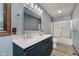 Bathroom featuring double sinks, wood-look tile floors, and a shower and tub combo at 11354 Royal Pl, Carmel, IN 46032