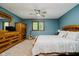 Bedroom featuring wooden furniture set, a ceiling fan, and a view of the backyard at 11354 Royal Pl, Carmel, IN 46032