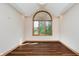 Bright room with a large window offering ample natural light and hardwood floors at 11354 Royal Pl, Carmel, IN 46032