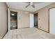 Bedroom featuring neutral carpeting, ceiling fan, and three doorways to closet, bathroom, and hall at 11354 Royal Pl, Carmel, IN 46032