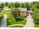 Beautiful brick home featuring manicured landscaping, mature trees, and spacious driveway at 11354 Royal Pl, Carmel, IN 46032