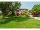 Charming two-story brick home with a well-manicured lawn and lush landscaping at 11354 Royal Pl, Carmel, IN 46032