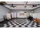 Spacious garage with checkerboard flooring, ample storage cabinets and work area at 11354 Royal Pl, Carmel, IN 46032