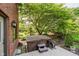 Outdoor hot tub on a wooden deck, surrounded by lush landscaping and trees at 11354 Royal Pl, Carmel, IN 46032