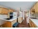 Well-equipped kitchen featuring stainless appliances, laminate countertops, wood cabinets, island, and access to dining room at 11354 Royal Pl, Carmel, IN 46032
