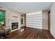 Inviting living room featuring a cozy fireplace, built-in shelving, and natural light, perfect for relaxing or entertaining at 11354 Royal Pl, Carmel, IN 46032