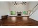 A large living room with a brick fireplace, hardwood floors, and many windows at 11354 Royal Pl, Carmel, IN 46032