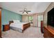 Serene main bedroom with a ceiling fan, natural light, and ample space, offering a relaxing retreat at 11354 Royal Pl, Carmel, IN 46032