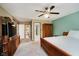 Spacious main bedroom featuring a ceiling fan, warm wood tones, and ample closet space for storage and comfort at 11354 Royal Pl, Carmel, IN 46032