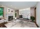 Bright office space featuring a fireplace, modern desk, neutral colors, and custom shelving perfect for a home office at 11354 Royal Pl, Carmel, IN 46032