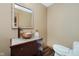 Stylish powder room with vessel sink, modern faucet, tiled vanity, and mosaic mirror, a sophisticated touch at 11354 Royal Pl, Carmel, IN 46032