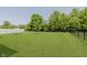 Well-manicured backyard with a hammock and partial fence at 11840 Crossbill Ct, Noblesville, IN 46060