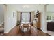 Traditional dining room with hardwood floors, a vintage hutch, a table, and natural lighting at 11840 Crossbill Ct, Noblesville, IN 46060