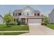 Charming two-story home with landscaped yard and a welcoming entrance, plus a two car garage at 11840 Crossbill Ct, Noblesville, IN 46060
